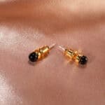 18K gold-plated black tourmaline mini stud earrings on a neutral background
