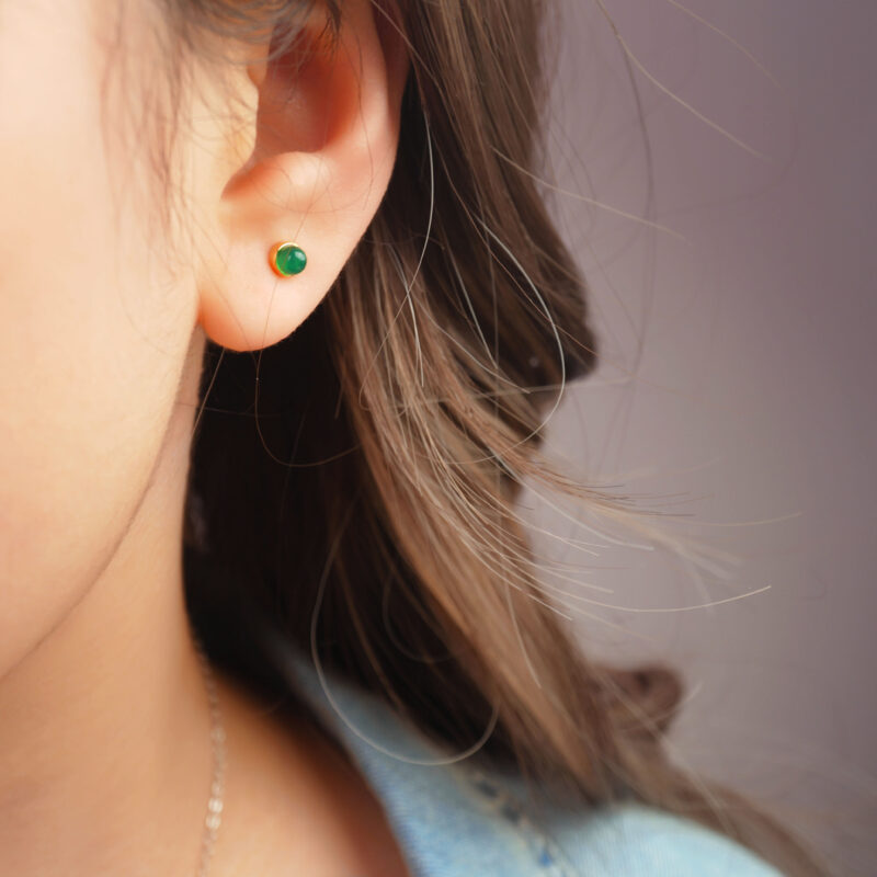 Model wearing the green agate mini studs, showing size and subtle sparkle