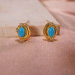 Close-up of turquoise stone texture and gold bezel detailing