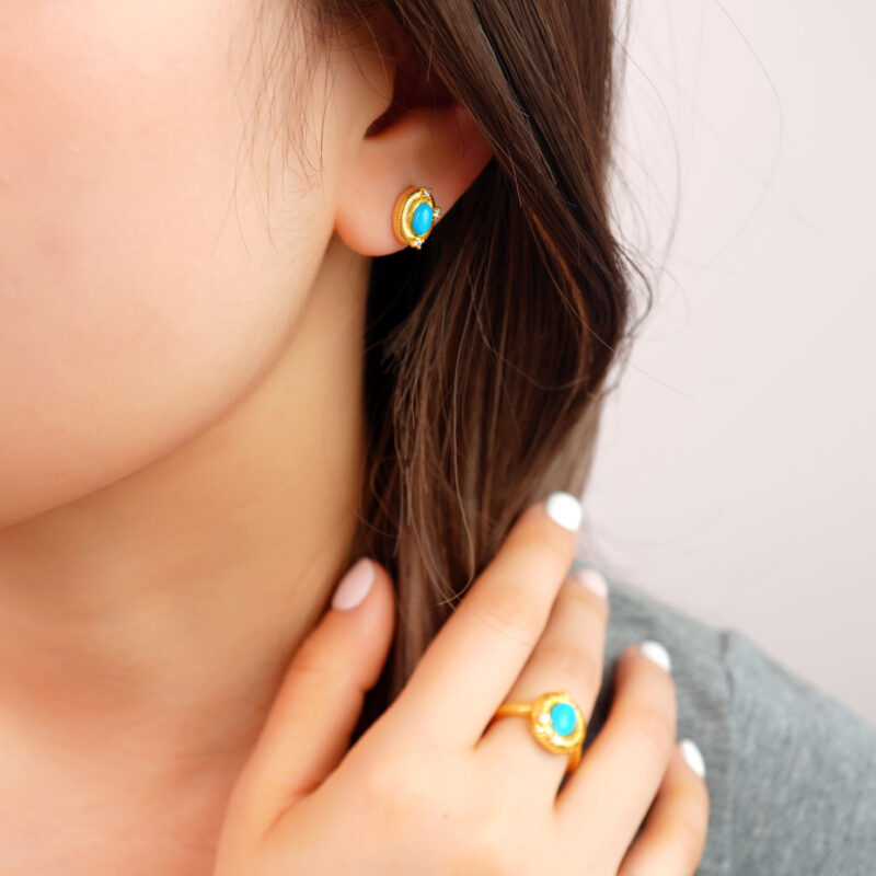 Model wearing the turquoise studs, showing size and warm-toned contrast