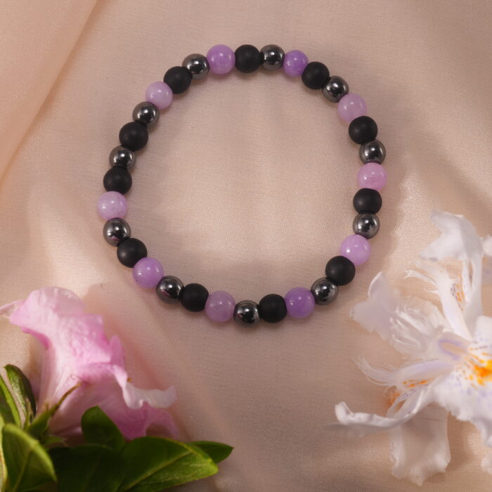 Bracelet resting on a natural stone surface under soft sunlight, evoking calm and clarity