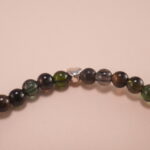 Close-up of natural black tourmaline beads and elastic threading
