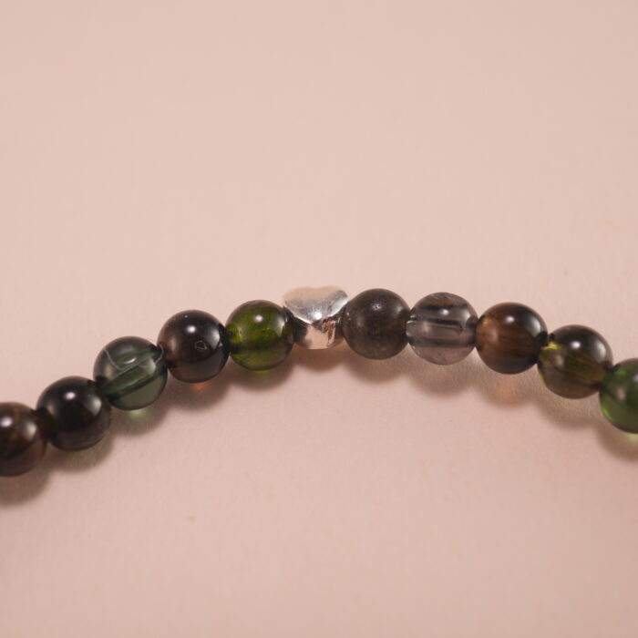 Close-up of natural black tourmaline beads and elastic threading