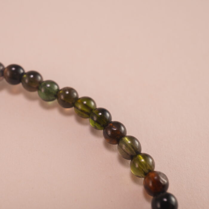 Close-up of natural black tourmaline beads and elastic threading