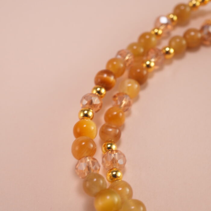 Close-up of Tiger Eye and White Crystal beads showing texture and shimmer
