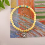Bracelet displayed near warm-toned accessories , showing its soft energy