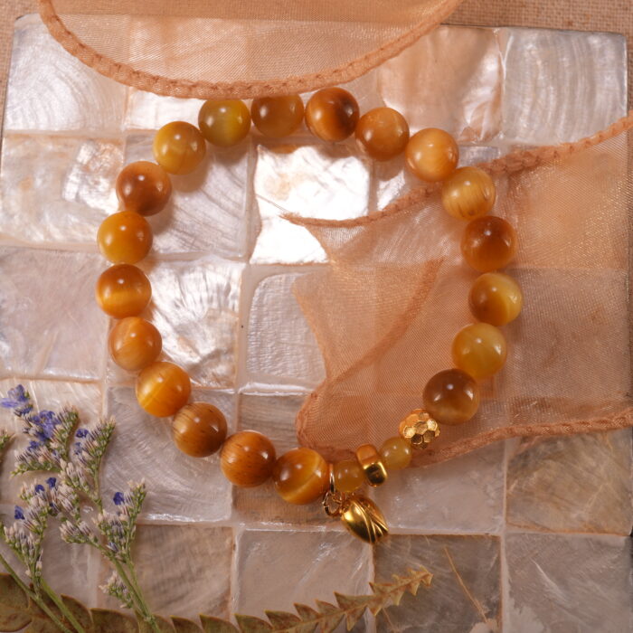 Citrine & Tiger Eye gold bracelet in a warm sunlight setting