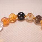 Close-up of faceted citrine beads and smooth gemstone texture