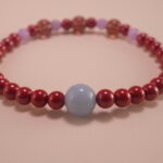 Close-up of rich red cinnabar beads with intricate carving details