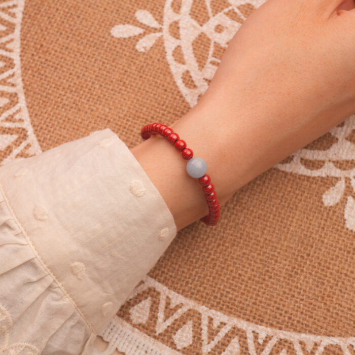 Model wearing cinnabar bracelet – bold red tones enhancing wrist style