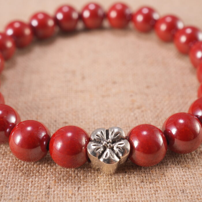 Close-up of cinnabar bead carvings and stringing details