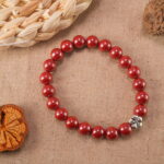 Cinnabar bracelet placed next to decorative ornaments