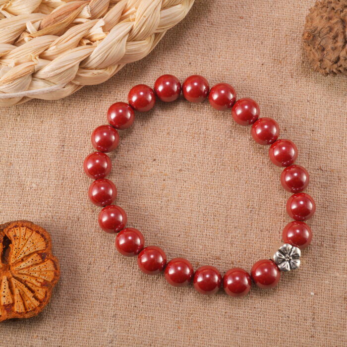 Cinnabar bracelet placed next to decorative ornaments