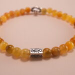 Close-up of tiger eye beads showing golden-brown stripes and silver accents