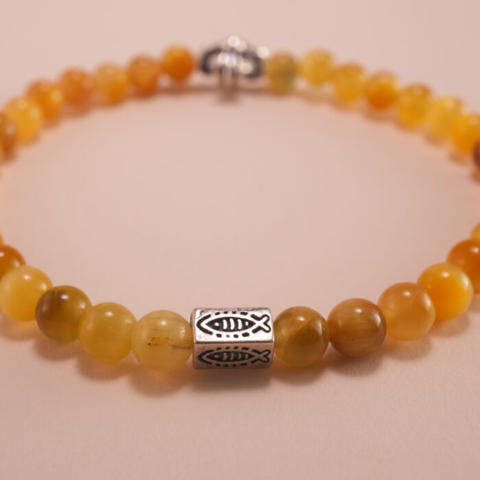Close-up of tiger eye beads showing golden-brown stripes and silver accents
