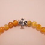 Close-up of tiger eye beads showing golden-brown stripes and silver accents