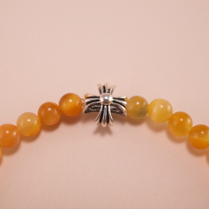 Close-up of tiger eye beads showing golden-brown stripes and silver accents