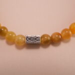 Close-up of tiger eye beads showing golden-brown stripes and silver accents