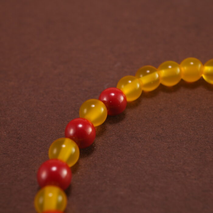 Close-up of cinnabar floral beads and vibrant agate stones