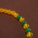 Close-up of cinnabar floral beads and vibrant agate stones