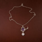 Amethyst moon pendant necklace on a soft white or celestial-themed background