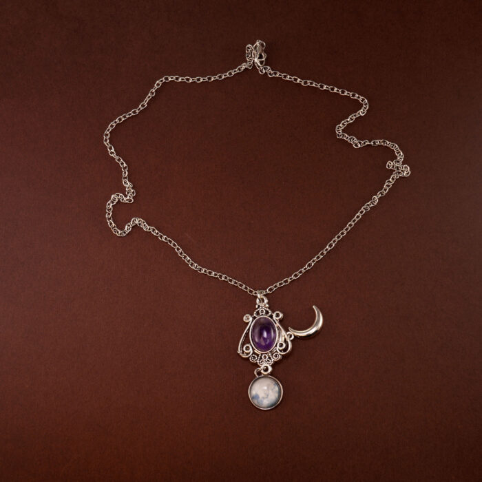 Amethyst moon pendant necklace on a soft white or celestial-themed background