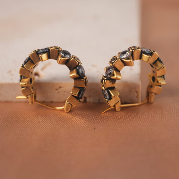 Close-up of hoop design and black diamond detail on the ear clips