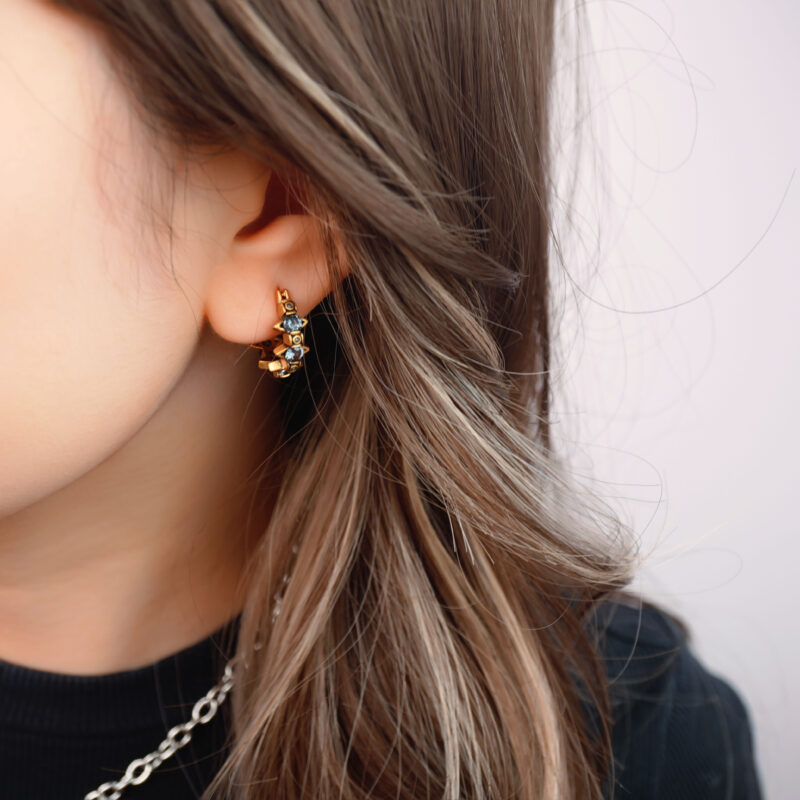 Model wearing the clip-on earrings, showcasing the fit for non-pierced ears