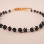 Close-up of genuine black tourmaline beads on adjustable bracelet