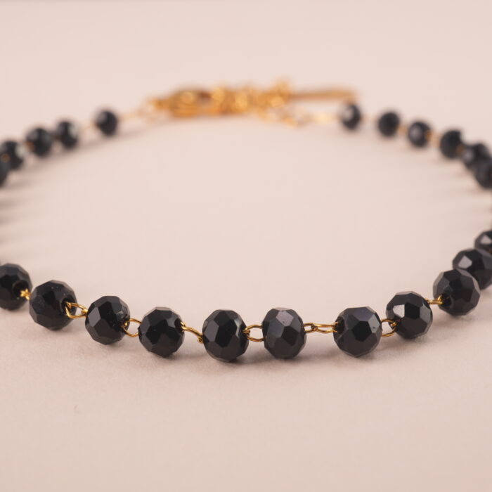 Close-up of genuine black tourmaline beads on adjustable bracelet