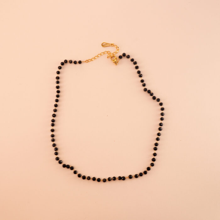 Dainty black tourmaline and obsidian necklace on a neutral or white background