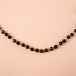 Close-up of small black crystal beads and chain detail