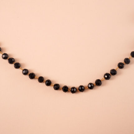 Close-up of small black crystal beads and chain detail