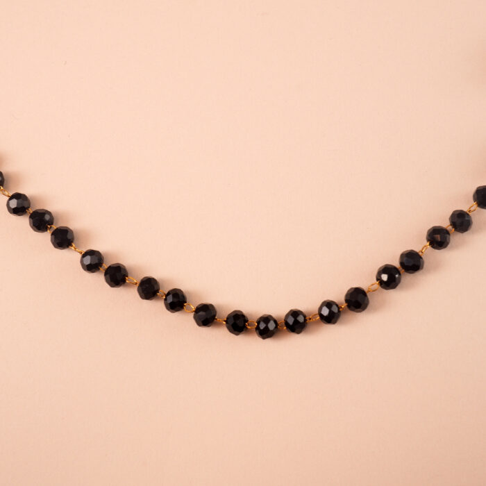 Close-up of small black crystal beads and chain detail