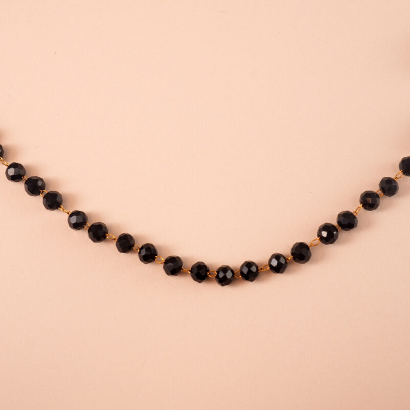Close-up of small black crystal beads and chain detail