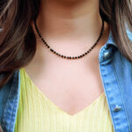 Model wearing the dainty necklace, showing lightweight and sleek silhouette
