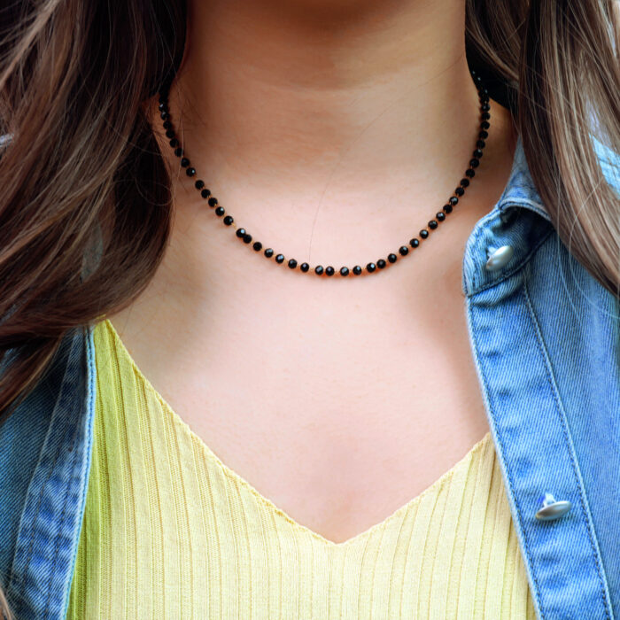 Model wearing the dainty necklace, showing lightweight and sleek silhouette
