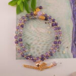 Woman meditating wearing amethyst double wrap bracelet for relaxation and restful slee