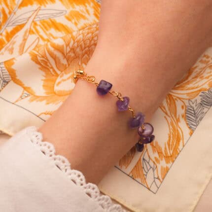 Amethyst gemstone bracelet styled on wrist with relaxed outfit