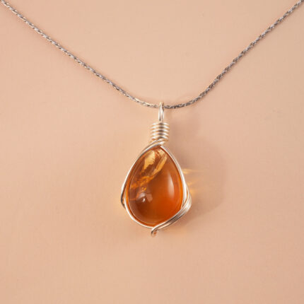 Handcrafted citrine pendant necklace with golden hues on a white or soft neutral background