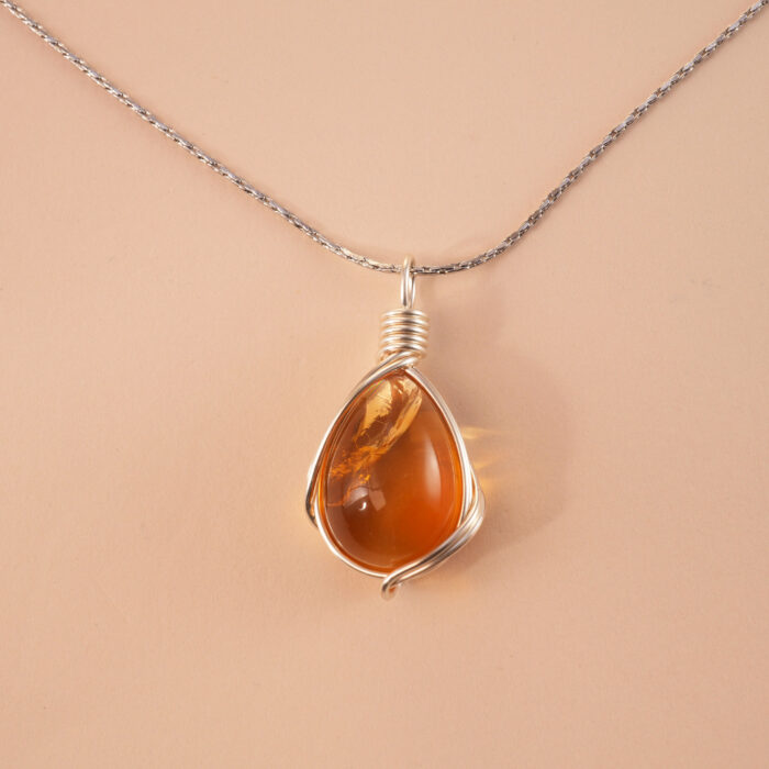 Handcrafted citrine pendant necklace with golden hues on a white or soft neutral background