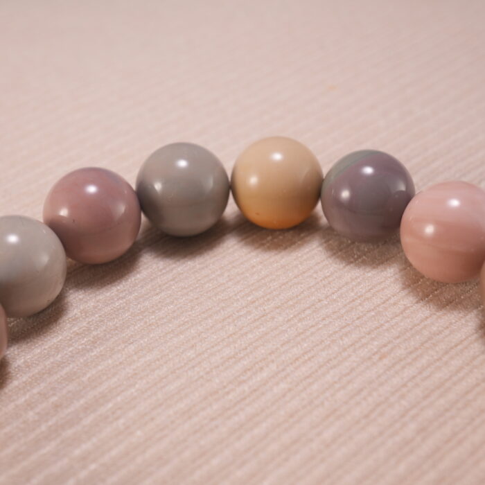 Close-up of natural stone heart bracelet showing handcrafted details