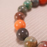 Close-up of natural stone beads and silver accents on beaded bracelet