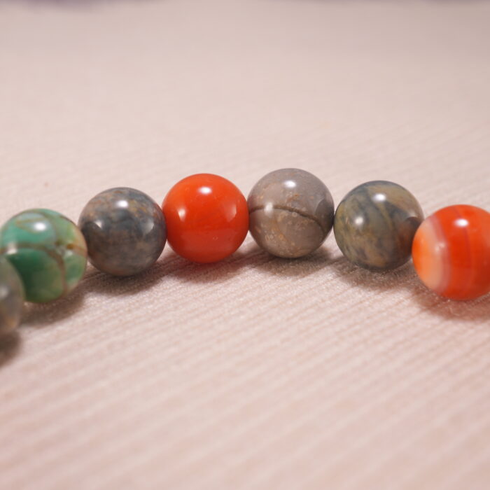 Close-up of natural stone beads and silver accents on beaded bracelet