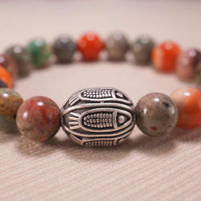 Close-up of natural stone beads and silver accents on beaded bracelet