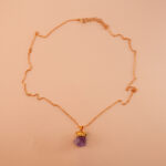 Handmade amethyst pendant necklace on soft neutral background