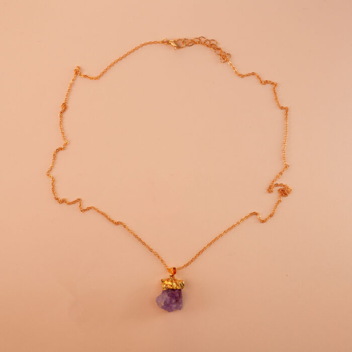 Handmade amethyst pendant necklace on soft neutral background