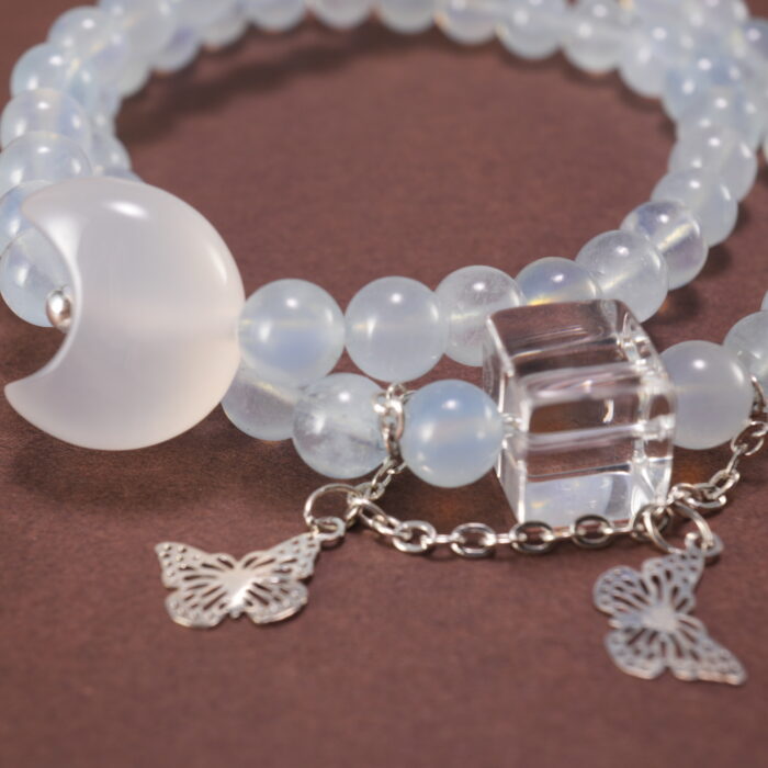 Close-up of Aquamarine Beads, Kyanite Stones, and Delicate Charms – Moon and Butterfly Design