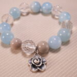 Close-up of Aquamarine and Clear Quartz Beads with Oxidized Flower Charm