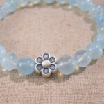Close-up of Aquamarine Beads and Oxidized Silver Flower Charm
